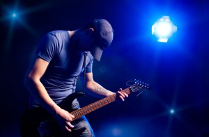 man playing on electric guitar